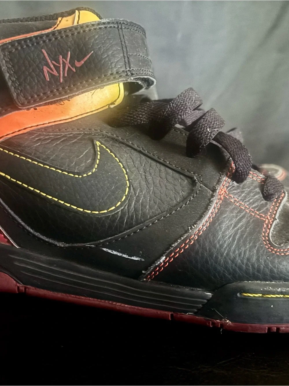 Nike Black High-Top Sneakers with Yellow Stitching and Red Accents